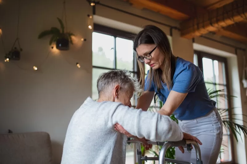 Caregiver assisting with transport and mobility
